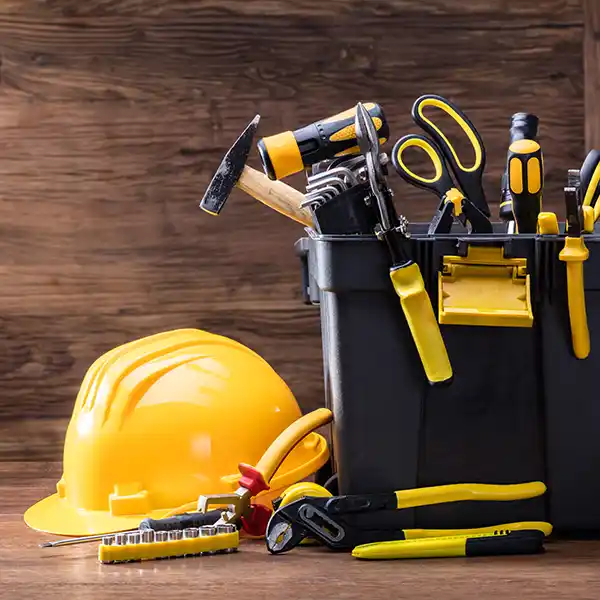 Yellow hardhat next to a large toolbox